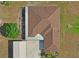 An aerial view of a home showcasing its roof and layout in a serene, green setting at 39427 Comstock Ln, Zephyrhills, FL 33540