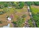 Aerial shot displays a home with expansive land, mature trees, and a serene setting in a wooded environment at 39427 Comstock Ln, Zephyrhills, FL 33540