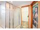This bathroom offers a glass enclosed shower and a walk-in closet with a unique beaded curtain at 39427 Comstock Ln, Zephyrhills, FL 33540