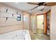 Luxurious bathroom with jacuzzi tub, walk-in shower, tile floor, and shelving at 39427 Comstock Ln, Zephyrhills, FL 33540