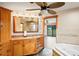 Bright bathroom featuring a custom vanity, soaking tub, and an open view to the backyard at 39427 Comstock Ln, Zephyrhills, FL 33540
