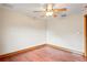 This bedroom showcases hardwood floors, ceiling fan, and ample space for customization at 39427 Comstock Ln, Zephyrhills, FL 33540