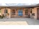 Charming enclosed front porch with blue double doors at 39427 Comstock Ln, Zephyrhills, FL 33540