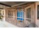 Inviting front entrance featuring a secure, decorative gate and a vibrant blue front door at 39427 Comstock Ln, Zephyrhills, FL 33540