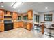 Kitchen features light wood cabinetry, tile countertops, and stainless steel appliances at 39427 Comstock Ln, Zephyrhills, FL 33540