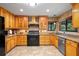 Bright kitchen boasts light wood cabinets, tile backsplash, and stainless steel appliances at 39427 Comstock Ln, Zephyrhills, FL 33540