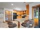 Bright kitchen with wood cabinetry, granite counters, breakfast bar, and wicker bar stools at 39427 Comstock Ln, Zephyrhills, FL 33540