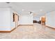 Unfurnished living room with tile floors and ceiling fans plus view of additional rooms at 39427 Comstock Ln, Zephyrhills, FL 33540