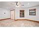 Open-concept living space with tiled floors and ceiling fan at 39427 Comstock Ln, Zephyrhills, FL 33540