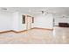 Unfurnished living room offers tiled floors, neutral paint, and a ceiling fan at 39427 Comstock Ln, Zephyrhills, FL 33540
