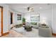 Bright living room features tiled floors, neutral paint, and an elegant ceiling fan and lots of natural light at 39427 Comstock Ln, Zephyrhills, FL 33540