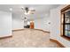 Unfurnished living room with tile floors and ceiling fans plus view of additional rooms at 39427 Comstock Ln, Zephyrhills, FL 33540