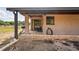 Covered outdoor patio with brick pavers, access to backyard and outdoor hose at 39427 Comstock Ln, Zephyrhills, FL 33540