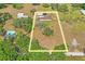 Aerial view outlining property lines of a home with mature trees and a expansive plot of land in a serene setting at 39427 Comstock Ln, Zephyrhills, FL 33540