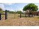 Fenced yard with green grass, mature trees, and a spacious area for recreation at 39427 Comstock Ln, Zephyrhills, FL 33540