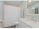 Bathroom with white vanity, marble countertop, and shower with white curtain at 4027 Alabama Ne Ave, St Petersburg, FL 33703