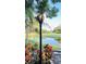 Backyard view featuring water, a gas torch, and lush landscaping at 4872 Silverthorne Ct, Oldsmar, FL 34677