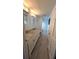 Bright bathroom features a double vanity with stone countertop and sleek tile flooring at 4872 Silverthorne Ct, Oldsmar, FL 34677