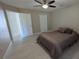 This bedroom boasts an overhead fan and a closet, offering a tranquil space to relax and unwind at 4872 Silverthorne Ct, Oldsmar, FL 34677
