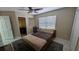Bedroom featuring neutral colored walls, a ceiling fan, light floors, and an adjacent bathroom at 4872 Silverthorne Ct, Oldsmar, FL 34677