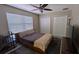Bedroom with a ceiling fan, modern style platform bed, two closets, and a window at 4872 Silverthorne Ct, Oldsmar, FL 34677