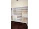 Walk-in closet featuring built-in shelving and hardwood floors at 4872 Silverthorne Ct, Oldsmar, FL 34677
