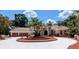 Stunning single-story home featuring a circular driveway, mature landscaping, and an attached two-car garage at 4872 Silverthorne Ct, Oldsmar, FL 34677