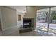 Modern fireplace with sliding glass door to covered patio at 4872 Silverthorne Ct, Oldsmar, FL 34677