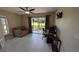 Office/Living room with neutral walls, white floors, patio door, and ceiling fan at 4872 Silverthorne Ct, Oldsmar, FL 34677