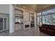 Living room features a fireplace, wet bar and wine fridge, wood ceiling, and large bright windows at 4872 Silverthorne Ct, Oldsmar, FL 34677