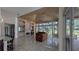 Bright living room boasts a built-in bar, fireplace, travertine floors and beautiful backyard views at 4872 Silverthorne Ct, Oldsmar, FL 34677