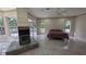 Spacious main bedroom with a fireplace, ensuite bathroom, large windows, and travertine floors at 4872 Silverthorne Ct, Oldsmar, FL 34677