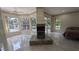Spacious main bedroom with a fireplace, ensuite bathroom, large windows, and travertine floors at 4872 Silverthorne Ct, Oldsmar, FL 34677