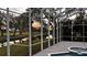 Relax in the screened patio overlooking a serene pond and lush landscape, perfect for enjoying the sunset at 4872 Silverthorne Ct, Oldsmar, FL 34677
