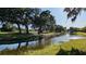 A beautiful view of a tranquil pond framed by lush trees, creating a serene and inviting atmosphere at 4872 Silverthorne Ct, Oldsmar, FL 34677