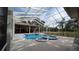 A screened pool with spa and patio overlooking a lush green backyard at 4872 Silverthorne Ct, Oldsmar, FL 34677