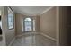 Bright room featuring marble floors, a bay window with arched transoms, and neutral paint at 4872 Silverthorne Ct, Oldsmar, FL 34677
