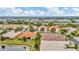 An aerial view showcases the community with lush landscaping and serene pond views at 4949 Marble Springs Cir, Wimauma, FL 33598