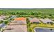 Aerial view of the community showcasing lush greenery, serene ponds, and well-maintained homes with tiled roofs at 4949 Marble Springs Cir, Wimauma, FL 33598