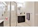 Modern bathroom featuring a glass shower, vanity with dark wood cabinets, and neutral toned tile at 4949 Marble Springs Cir, Wimauma, FL 33598