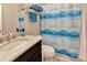 Bathroom featuring a dark vanity with a stone countertop and a shower-tub combo at 4949 Marble Springs Cir, Wimauma, FL 33598