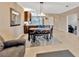 Open dining area with modern light fixture next to the kitchen and comfortable seating at 4949 Marble Springs Cir, Wimauma, FL 33598