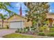 Charming single-story home with a well-manicured lawn, flag, and brick driveway at 4949 Marble Springs Cir, Wimauma, FL 33598