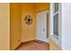 Front porch featuring brick-paved flooring, a decorative wreath, and a storm door at 4949 Marble Springs Cir, Wimauma, FL 33598