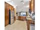 Spacious kitchen featuring stainless steel appliances, granite countertops, and ample cabinet space at 4949 Marble Springs Cir, Wimauma, FL 33598