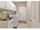 Laundry room with white cabinets, a sink, a washer, and an exterior access door at 4949 Marble Springs Cir, Wimauma, FL 33598
