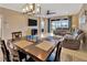 Open floor plan featuring a modern dining table and comfortable seating area with a ceiling fan at 4949 Marble Springs Cir, Wimauma, FL 33598