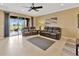 Spacious living room with comfortable seating and sliding door access to the outdoor living space at 4949 Marble Springs Cir, Wimauma, FL 33598