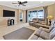 Comfortable living area with a television, access to the lanai, and neutral color palette at 4949 Marble Springs Cir, Wimauma, FL 33598