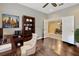 Home office featuring hardwood floors, adjacent dining area, and natural lighting at 4949 Marble Springs Cir, Wimauma, FL 33598